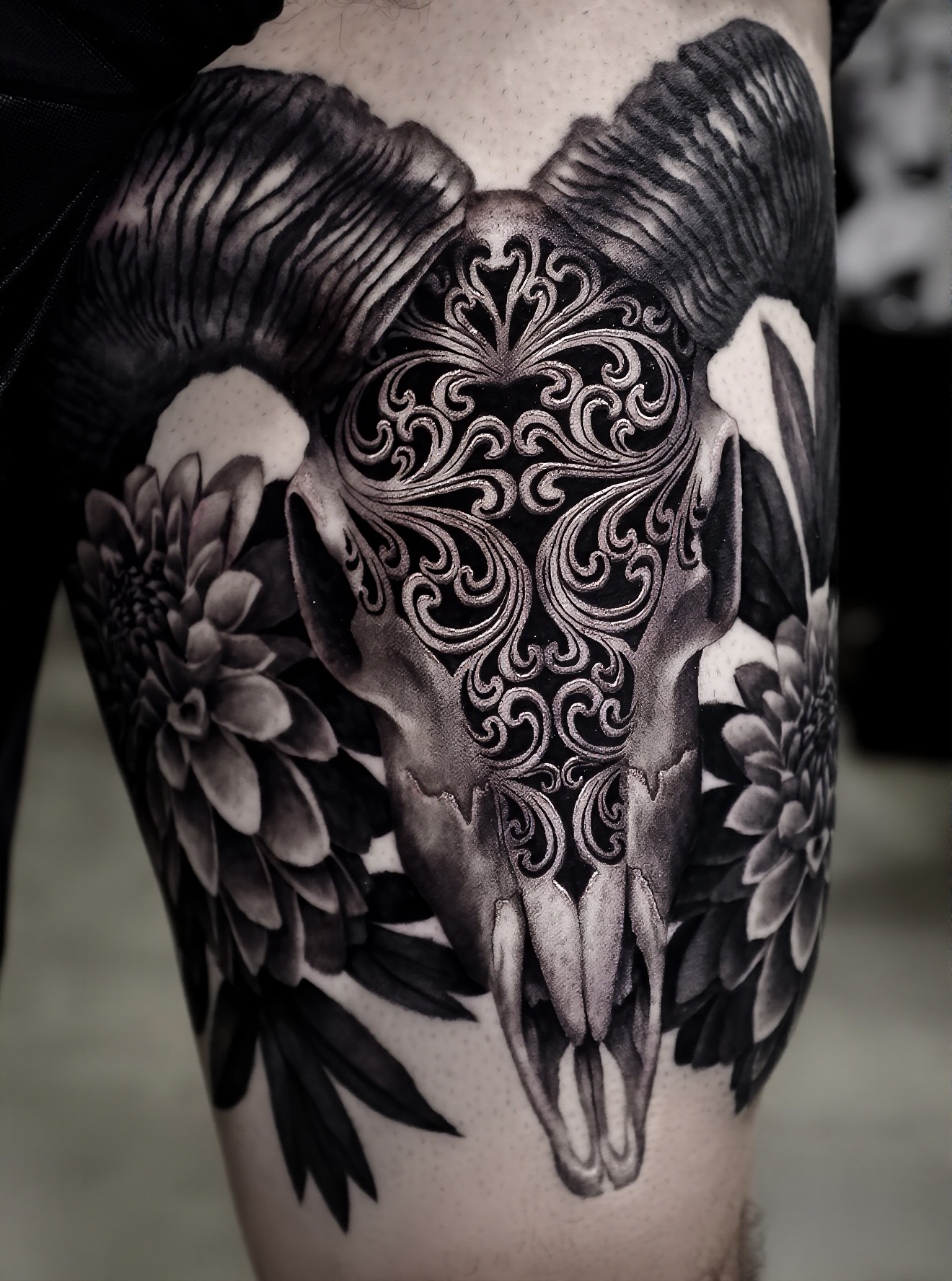 Ornate skull with wings and flowers tattoo by Steve Young
