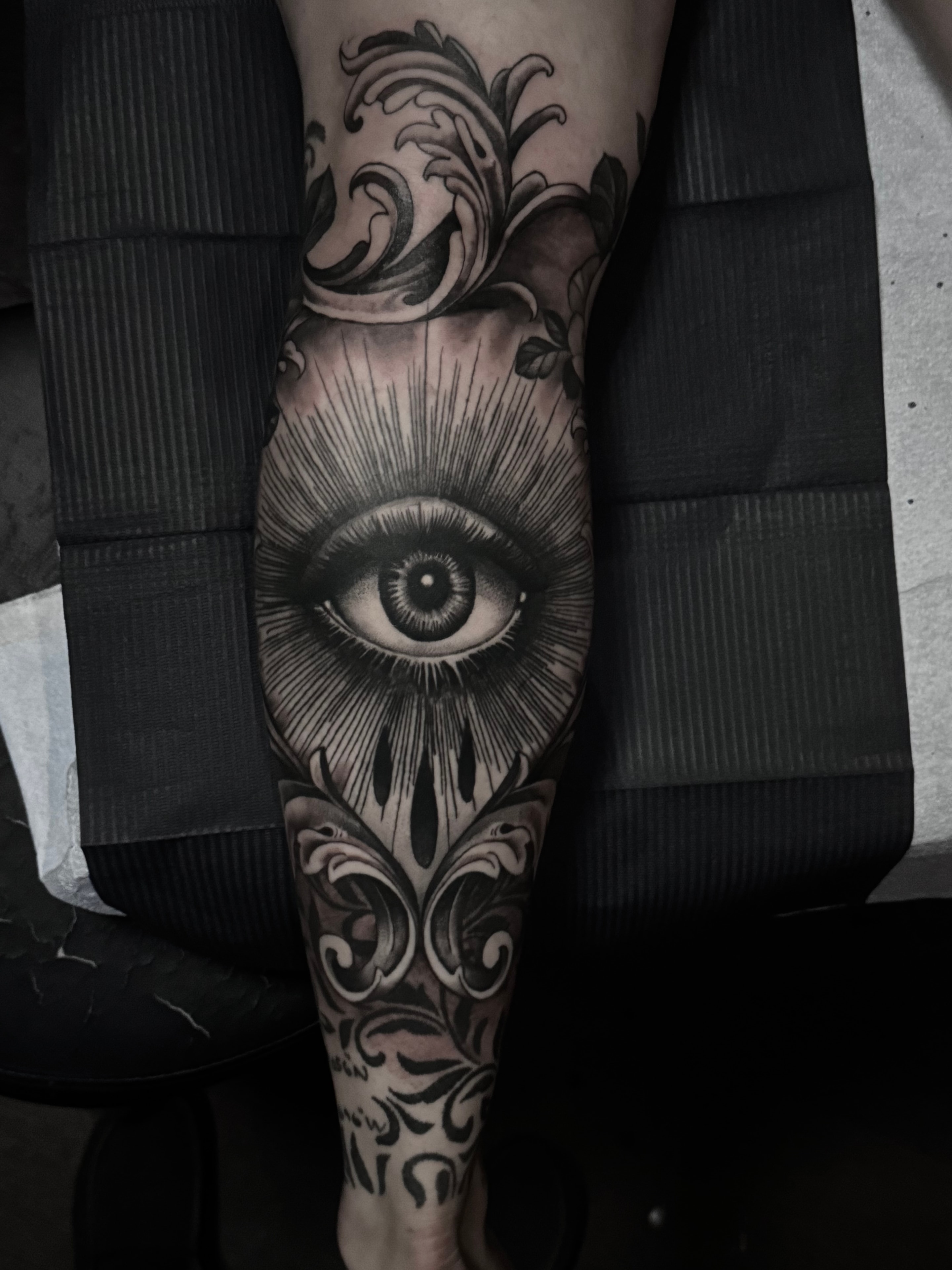 Ornate eye tattoo with baroque flourishes by Steve Young