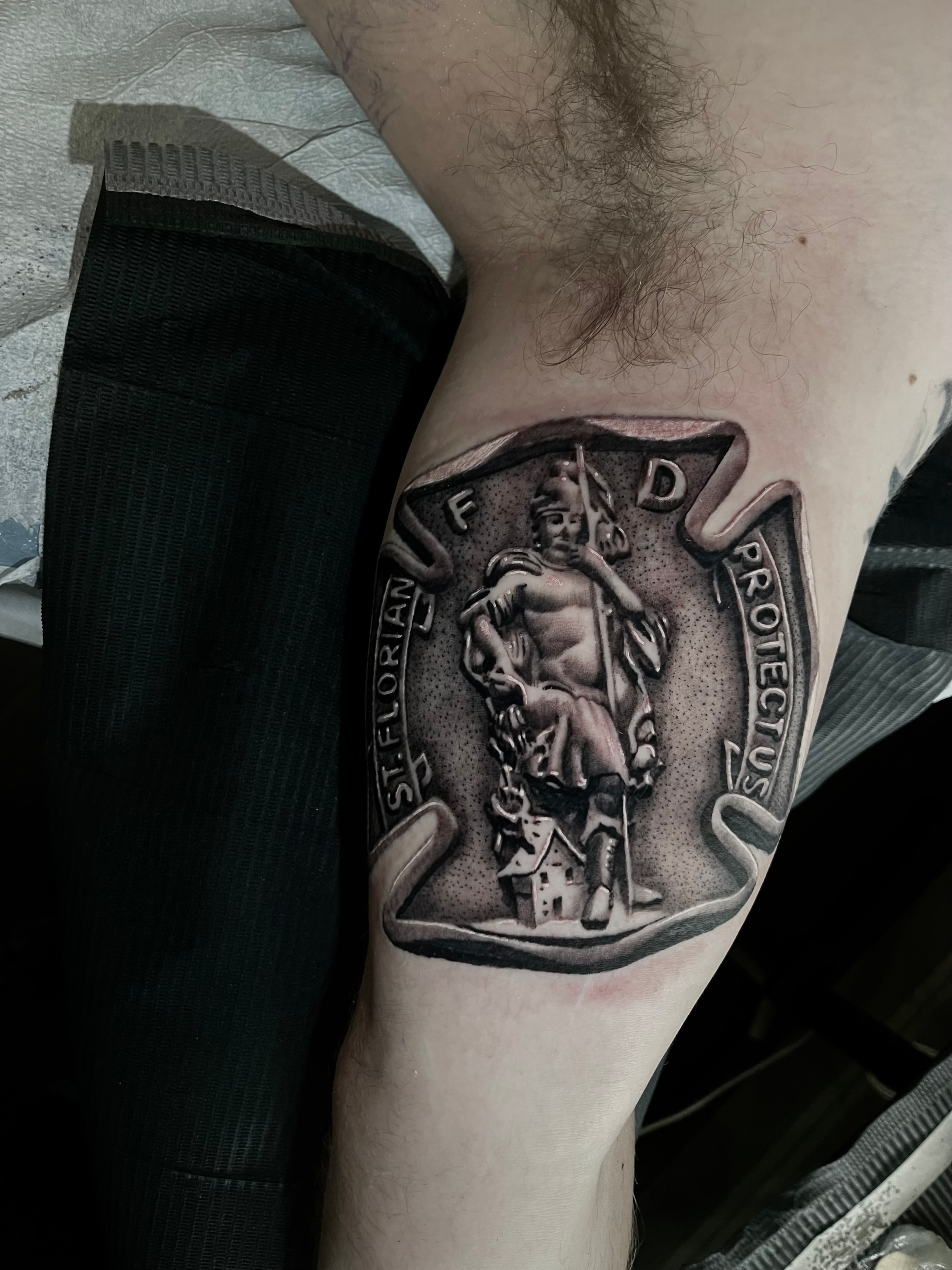 Saint Florian arm tattoo by Steve Young