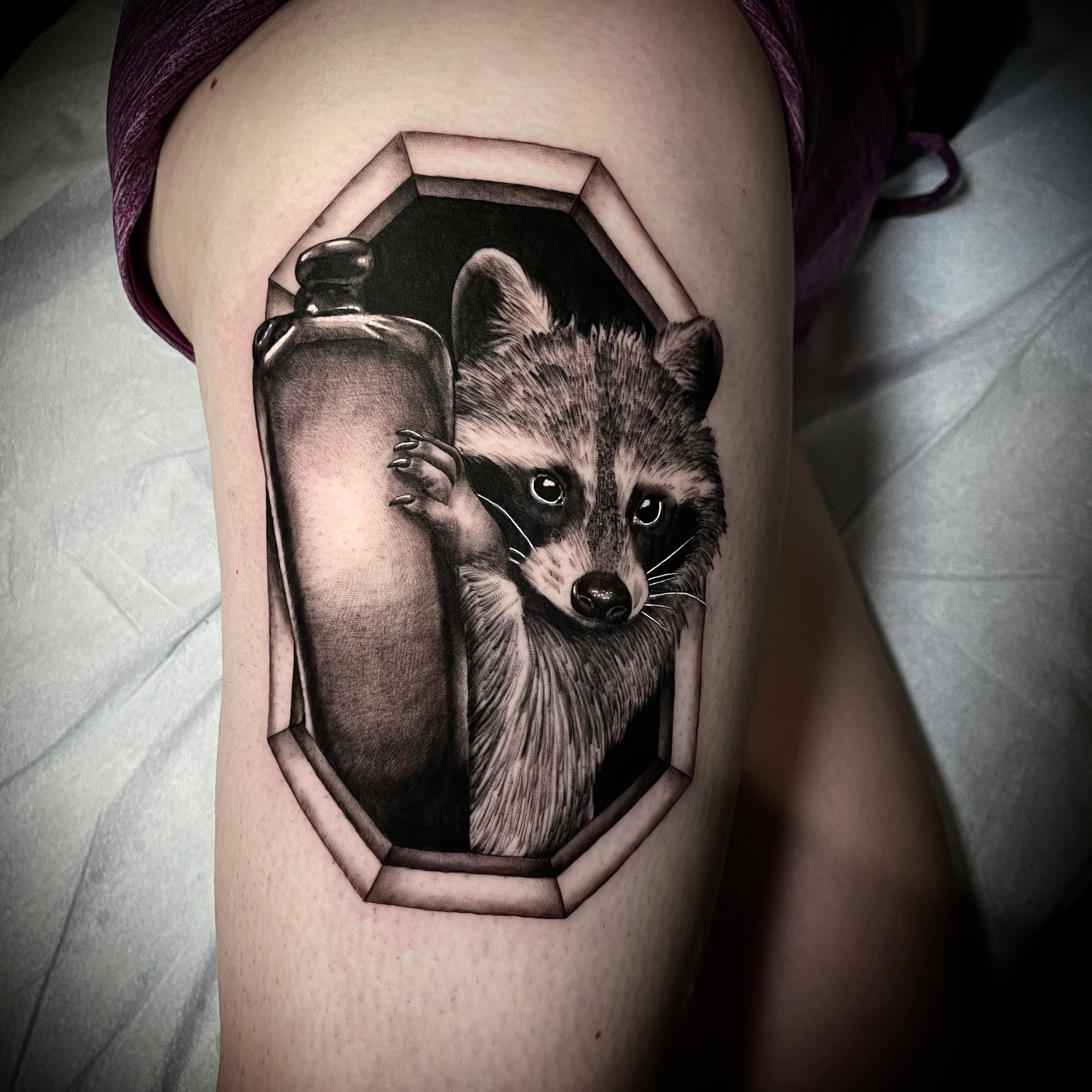 Raccoon holding spray can tattoo by Steve Young