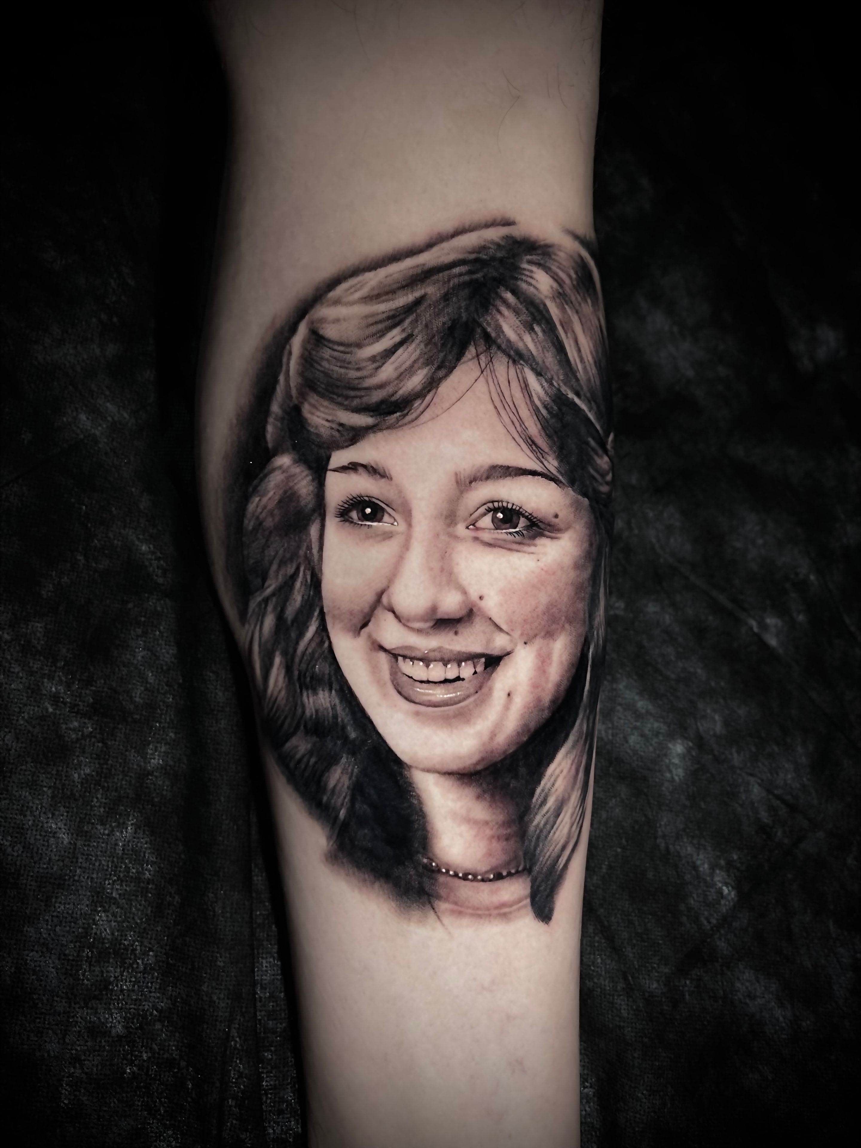 Portrait tattoo smiling woman arm by Steve Young