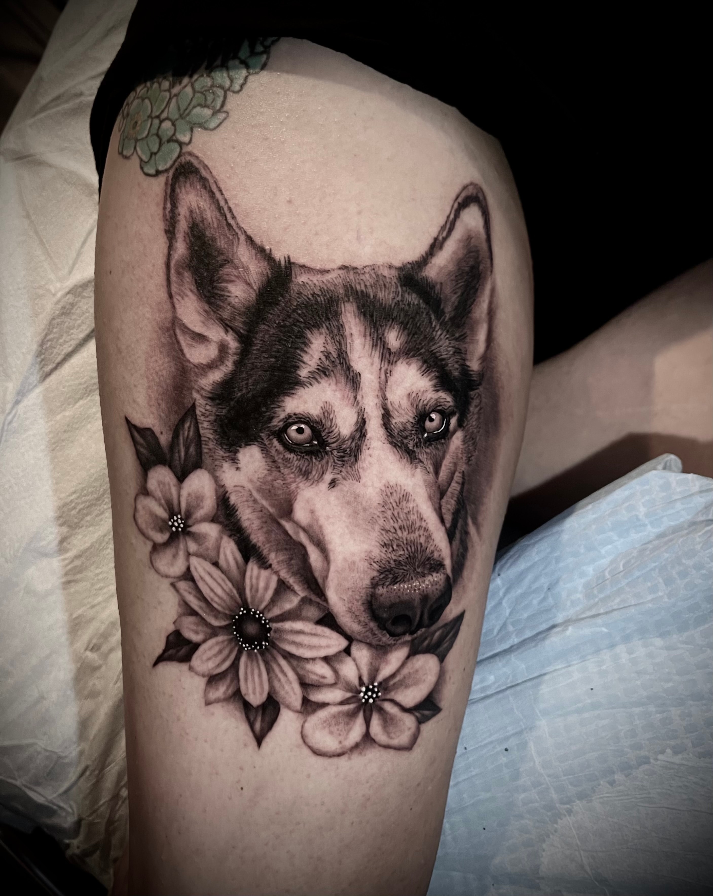 Husky dog portrait with flowers tattoo by Steve Young