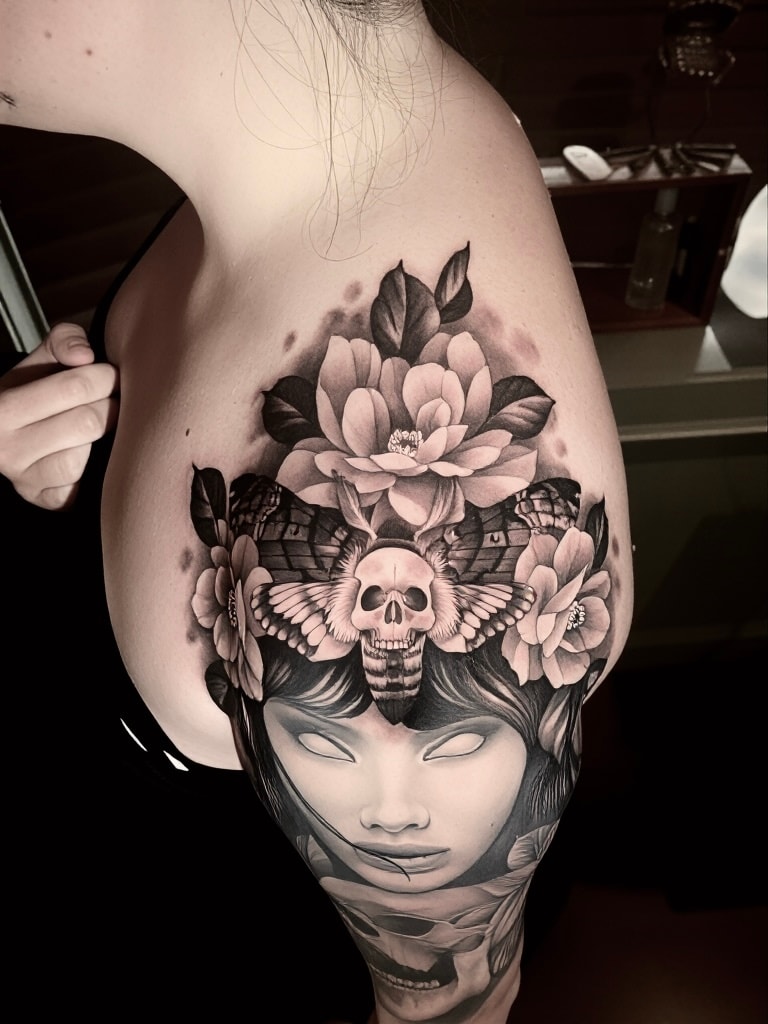 Skull moth flowers face tattoo thigh by Steve Young